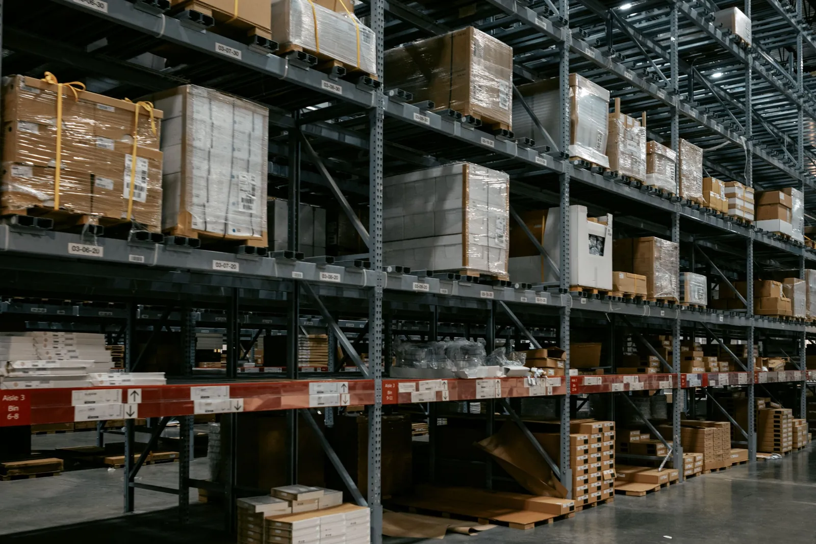 Rows of tall warehouse shelving loaded with palletized stock
