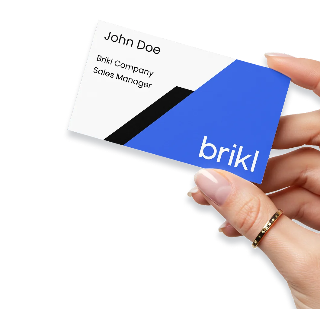 A hand holding a Brikl-branded business card printed on demand